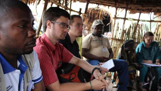 Michael J. Sharp, second from left, participates in a 2013 meeting at camp for internally displaced people in the town of Shasha, North Kivu, Eastern Congo.
