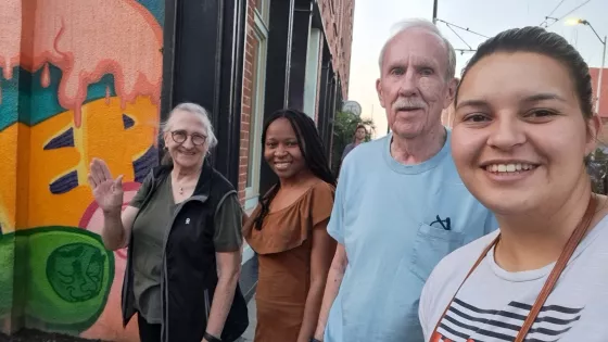 A group of four people smiling for a photo