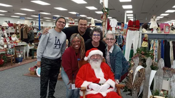 A group of people posing for a photo with Santa Claus