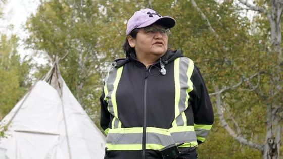 A woman standing looking to the side