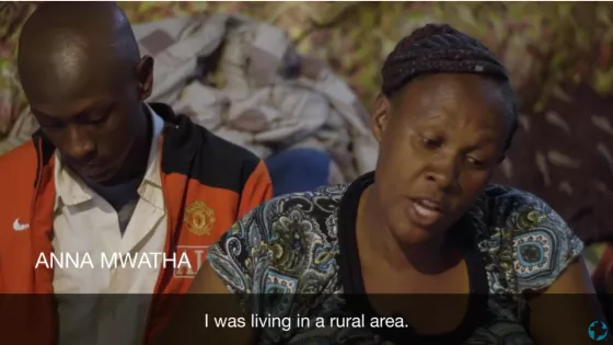 Two Kenyans sit in their makeshift home