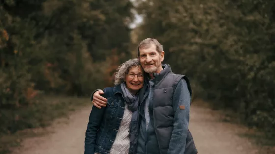 A photo of a couple smiling for a photo