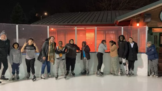 Charles, third from right, ice skates with the staff and children from Living Works’ after-school program.