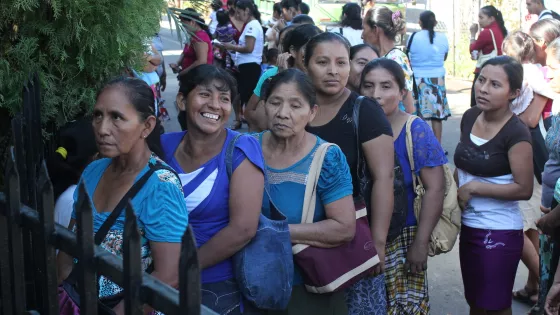 A group of woman smiling standing in a line