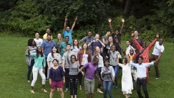 IVEP participants stand together in a grassy field.