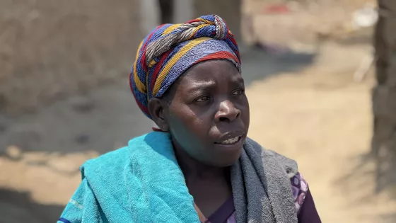 Nyiranshuti Atanaziya speaks with MCC staff at Zambia's Meheba Refugee Settlement Camp.