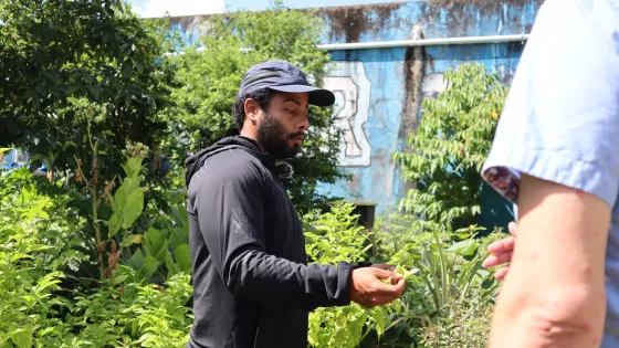 Garden coordinator of a community garden in Caguas, Puerto Rico, give a tour of the garden.