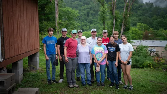 The youth group from Alexanderwohl Mennonite Church in Gossel Kansas stand with Dottie Fleming, center, after working on her home in Virgie, Kentucky for a week.