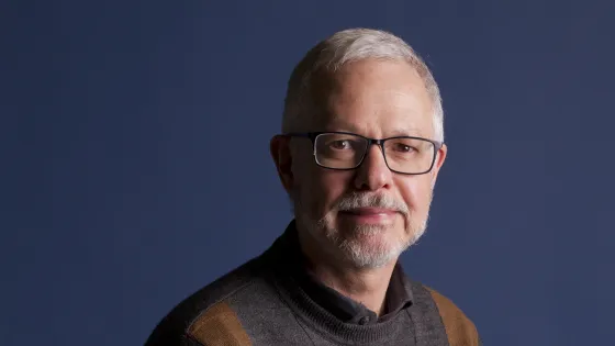 A portrait of a man with glasses