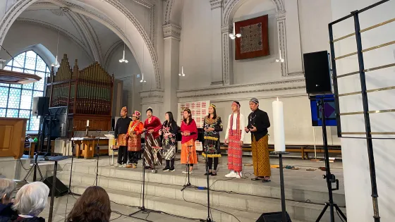 A choir stands in a church