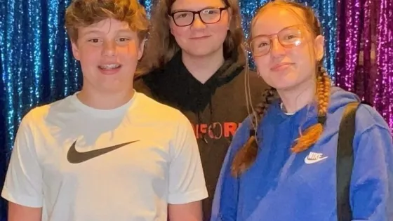 Max Bennett, Dane Yoder and Roslyn Shenk, members of the youth group at Toledo (Ohio) Mennonite Church, gather for a photo.