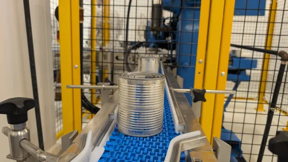 A can of meat makes its way along a conveyor belt at the meat cannery.