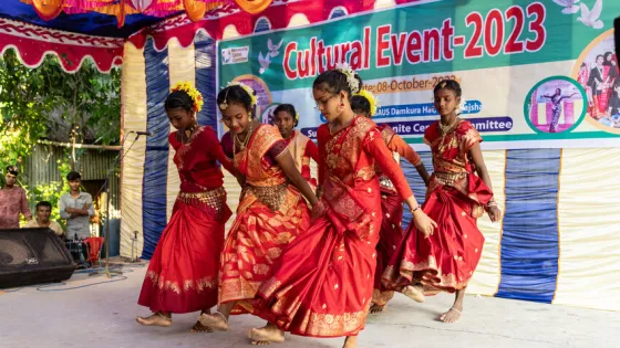 Young women from Santali and Mahali Indigenous groups perform a Mahali dance in a cultural program organized by MAASAUS.