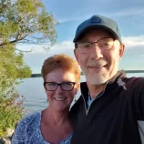 A man and woman smiling taking a selfie style photo
