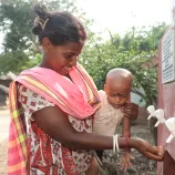 Monju Soren and her friends daughter, Promila (of India) collect clean water from a submersible pump.